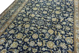Backside of handmade 2000s Kashan rug showing knot structure and weave density