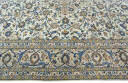 Corner detail of 2000s Kashan rug showing border pattern and Wool pile