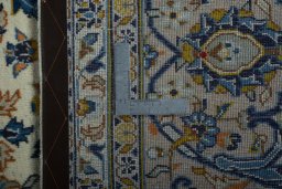 Backside of handmade 2000s Kashan rug showing knot structure and weave density