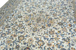 Backside of handmade 2000s Kashan rug showing knot structure and weave density