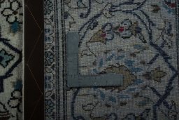 Backside of handmade 2000s Kashan rug showing knot structure and weave density