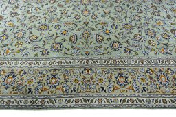 Corner detail of 2000s Kashan rug showing border pattern and Wool pile