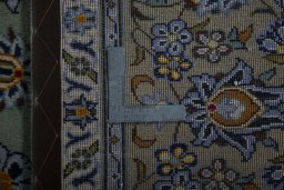 Backside of handmade 2000s Kashan rug showing knot structure and weave density