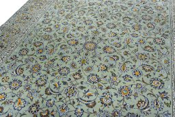 Backside of handmade 2000s Kashan rug showing knot structure and weave density