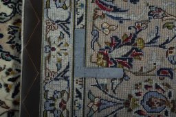 Backside of handmade 2000s Kashan rug showing knot structure and weave density