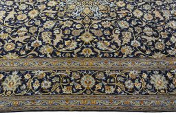 Corner detail of 2000s Kashan rug showing border pattern and Wool pile