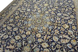 Backside of handmade 2000s Kashan rug showing knot structure and weave density
