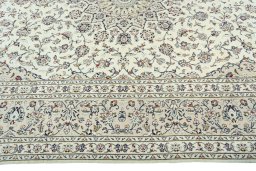Corner detail of 2000s Kashan rug showing border pattern and Cork pile