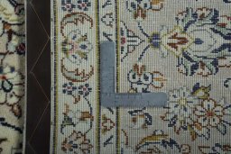 Backside of handmade 2000s Kashan rug showing knot structure and weave density