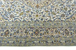 Corner detail of 2000s Kashan rug showing border pattern and Wool pile