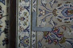 Backside of handmade 2000s Kashan rug showing knot structure and weave density