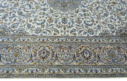 Corner detail of 2000s Kashan rug showing border pattern and Wool pile