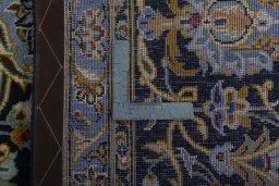 Backside of handmade 2000s Kashan rug showing knot structure and weave density