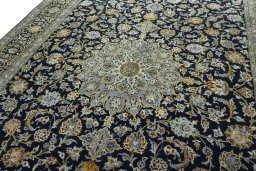 Backside of handmade 2000s Kashan rug showing knot structure and weave density