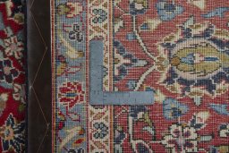 Backside of handmade 2000s Kashan rug showing knot structure and weave density