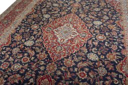 Backside of handmade 2000s Kashan rug showing knot structure and weave density