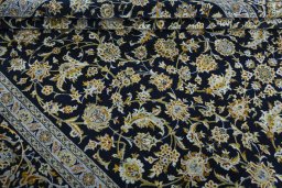 Corner detail of 2000s Kashan rug showing border pattern and Wool pile