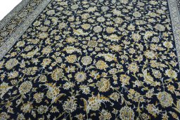 Backside of handmade 2000s Kashan rug showing knot structure and weave density