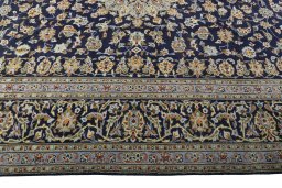 Corner detail of 2000s Kashan rug showing border pattern and Wool pile