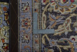 Backside of handmade 2000s Kashan rug showing knot structure and weave density