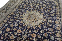 Backside of handmade 2000s Kashan rug showing knot structure and weave density