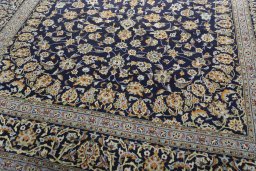Close-up detail of 2000s Kashan rug from Iran / Persia showing Wool weave