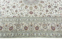 Corner detail of 2000s Kashan rug showing border pattern and Wool pile