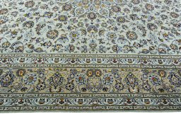 Corner detail of 2000s Kashan rug showing border pattern and Wool pile