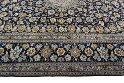 Corner detail of 2000s Kashan rug showing border pattern and Wool pile