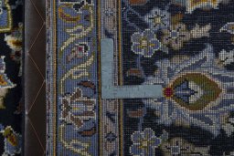 Backside of handmade 2000s Kashan rug showing knot structure and weave density