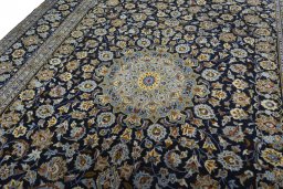 Backside of handmade 2000s Kashan rug showing knot structure and weave density