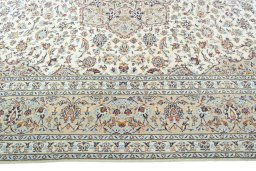 Corner detail of 2000s Kashan rug showing border pattern and Wool pile