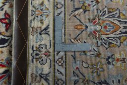 Backside of handmade 2000s Kashan rug showing knot structure and weave density