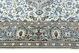Corner detail of 2000s Kashan rug showing border pattern and Wool pile