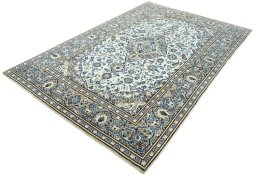 Corner detail of 2000s Kashan rug showing border pattern and Wool pile