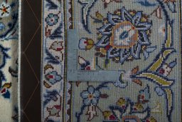 Backside of handmade 2000s Kashan rug showing knot structure and weave density
