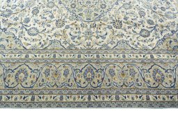Corner detail of 2000s Kashan rug showing border pattern and Wool pile