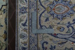 Backside of handmade 2000s Kashan rug showing knot structure and weave density
