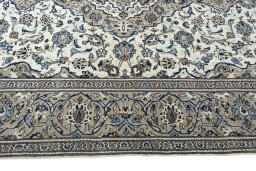 Corner detail of 2000s Kashan rug showing border pattern and Wool pile