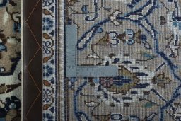 Backside of handmade 2000s Kashan rug showing knot structure and weave density