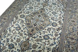 Backside of handmade 2000s Kashan rug showing knot structure and weave density