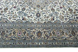 Corner detail of 2000s Kashan rug showing border pattern and Wool pile