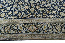 Corner detail of 2000s Kashan rug showing border pattern and Wool pile