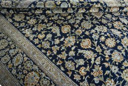 Close-up detail of 2000s Kashan rug from Iran / Persia showing Wool weave