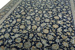 Backside of handmade 2000s Kashan rug showing knot structure and weave density