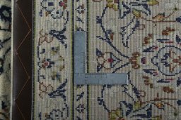 Backside of handmade 2000s Kashan rug showing knot structure and weave density