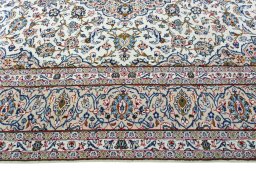 Corner detail of 2000s Kashan rug showing border pattern and Wool pile