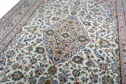 Backside of handmade 2000s Kashan rug showing knot structure and weave density