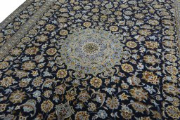 Backside of handmade 2000s Kashan rug showing knot structure and weave density