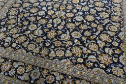 Close-up detail of 2000s Kashan rug from Iran / Persia showing Wool weave